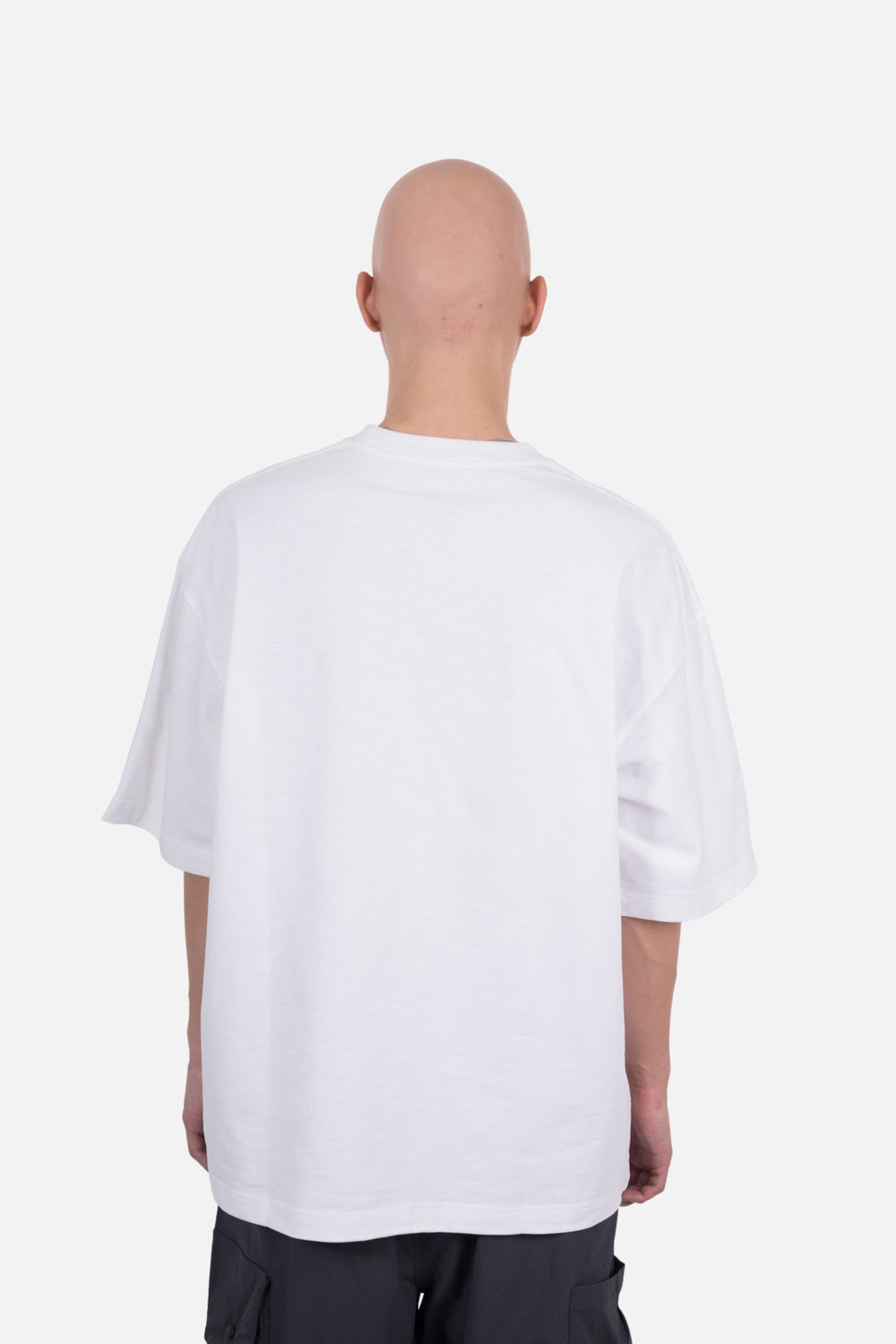 An oversized white T-shirt with a pocket design