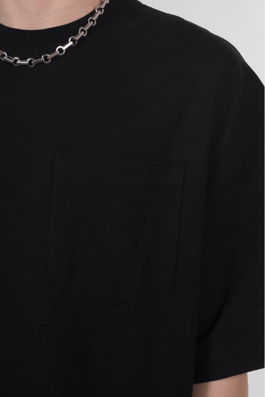 An oversized black T-shirt with a front pocket