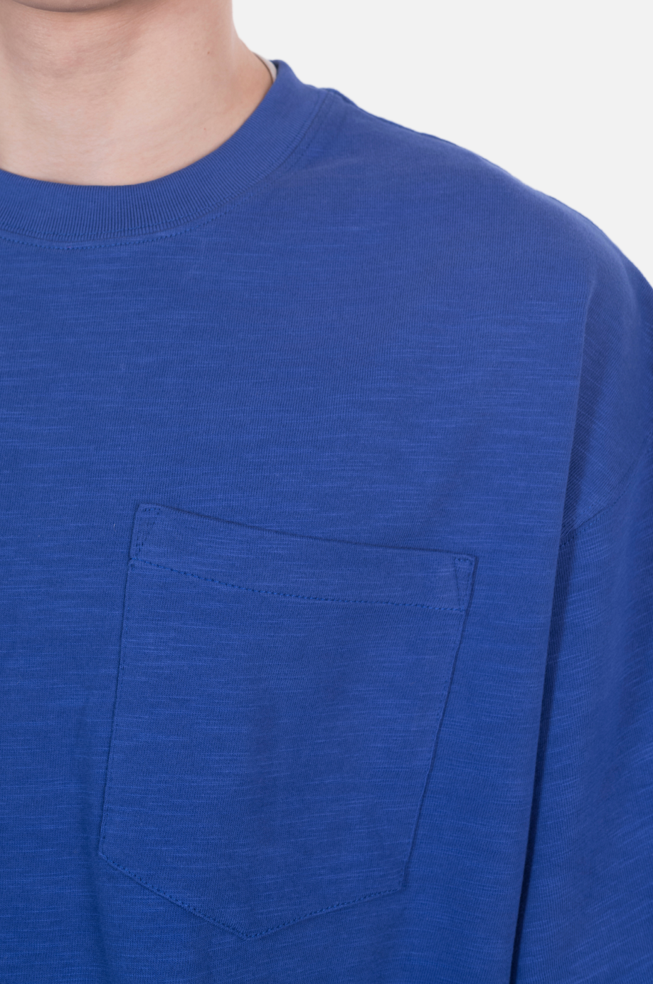 An oversized blue T-shirt with a front pocket
